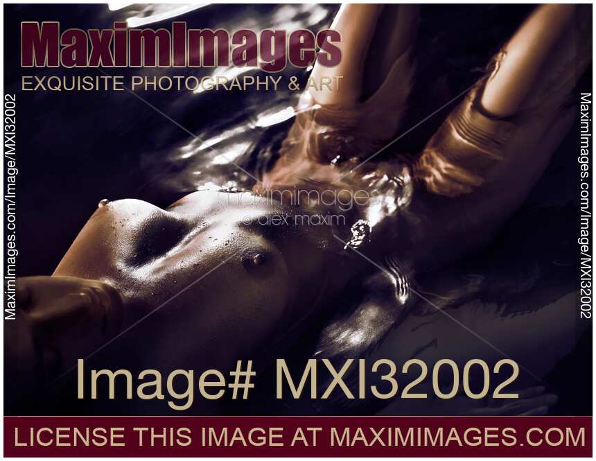Fine art nude of woman with dark shiny metallic skin lying naked submerged in glossy water