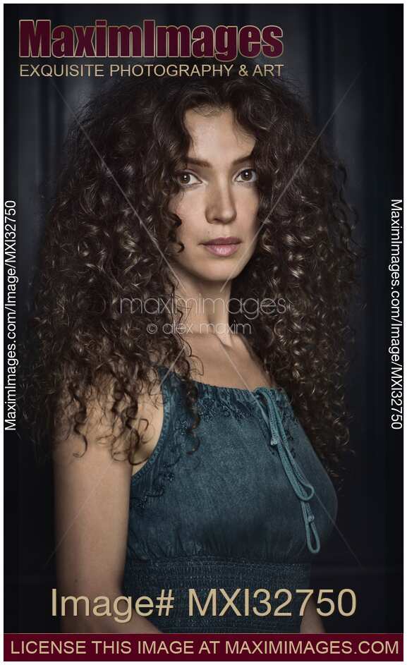 Fine art portrait of a Beautiful girl with big curly dark hair and expressive big dreamy eyes
