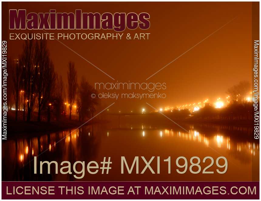 Foggy night city scenery over river canal