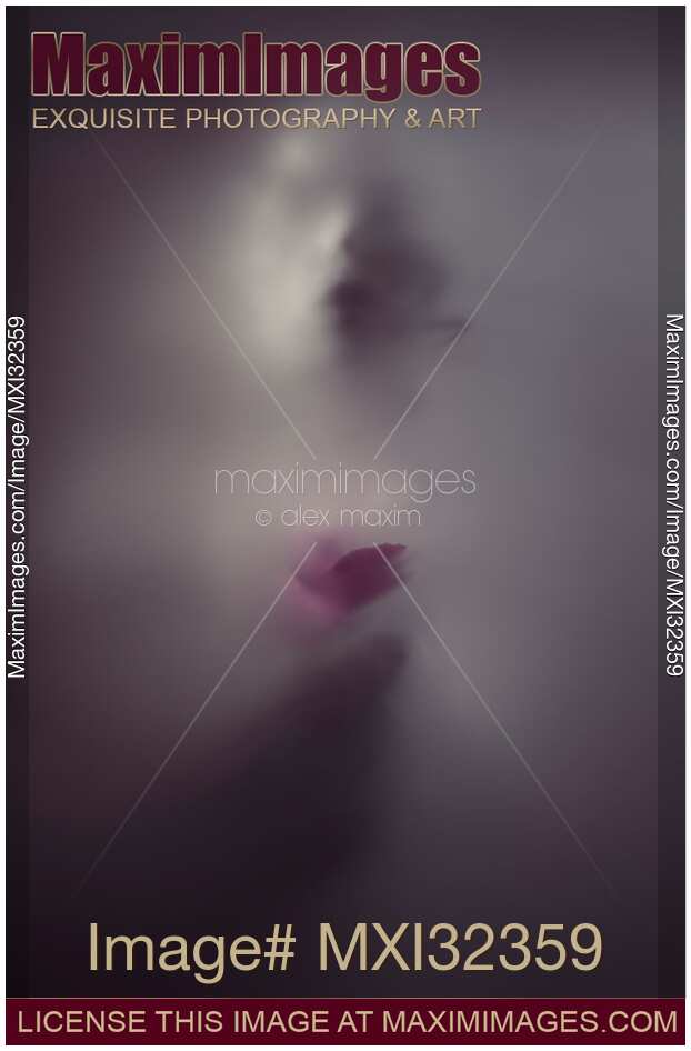 Ghostly woman face with a pink rose behind a veil of dense white suffocating fog