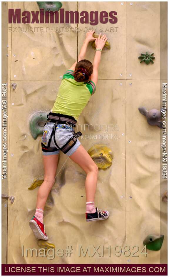 Girl Practicing on Climbing Wall