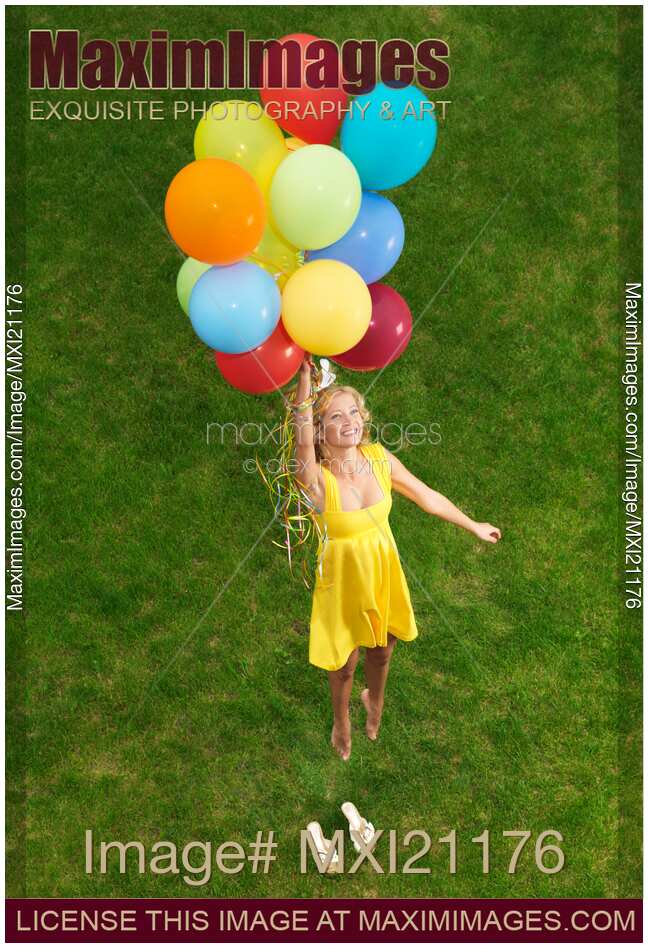 Girl with air balloons in mid-air