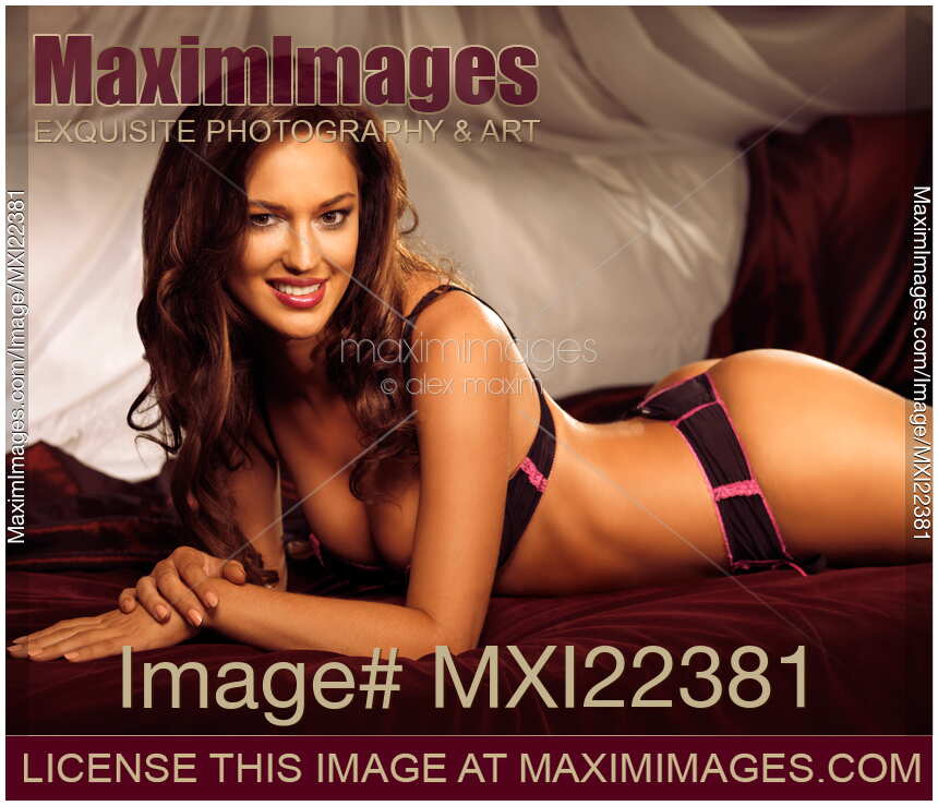 Glamour portrait of a Beautiful Sexy Woman Lying on a Bed