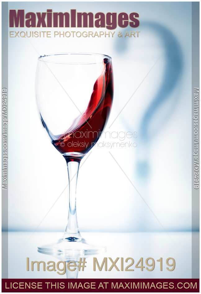 Glass of red wine in question artistic concept
