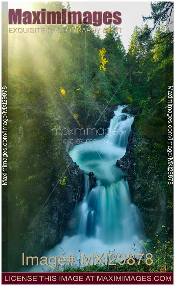 Glowing sunshine over beautiful cascade waterfall at Little Qualicum Falls Vancouver Island Canada