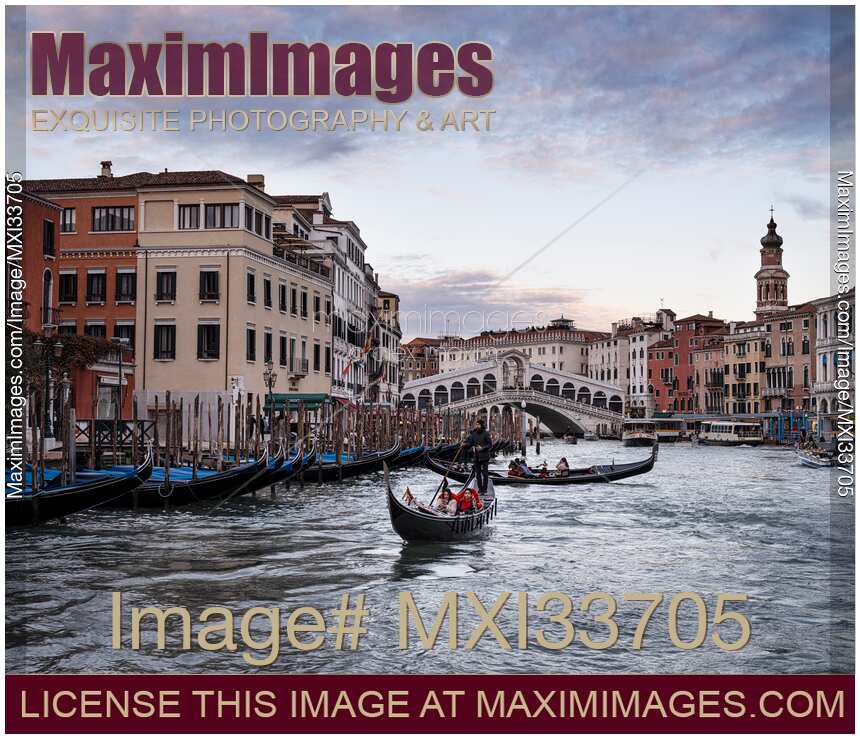 Gondolas at Venice Grand Canal with beautiful historic Venetian architecture and the Rialto Bridge