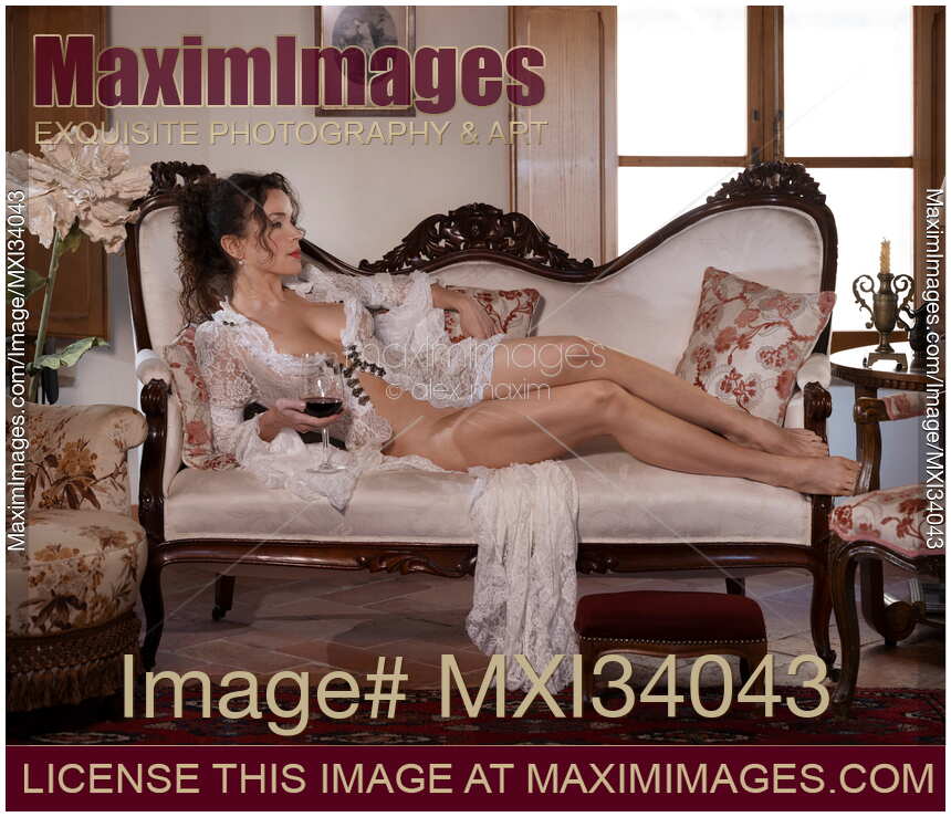 Gorgeous sexy lady Venetian courtesan with sensual nude body lying naked in historic house with a glass of wine