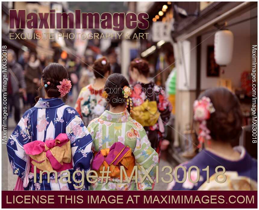 Group of girls in bright Yukatas walking on Matsubara dori street in Kyoto near Kiyomizu-dera