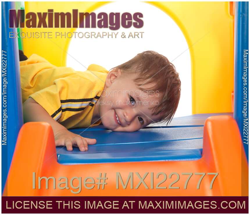Happy Child Climbing on a Slide