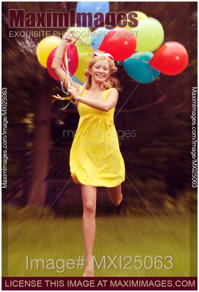 Happy young woman running with balloons