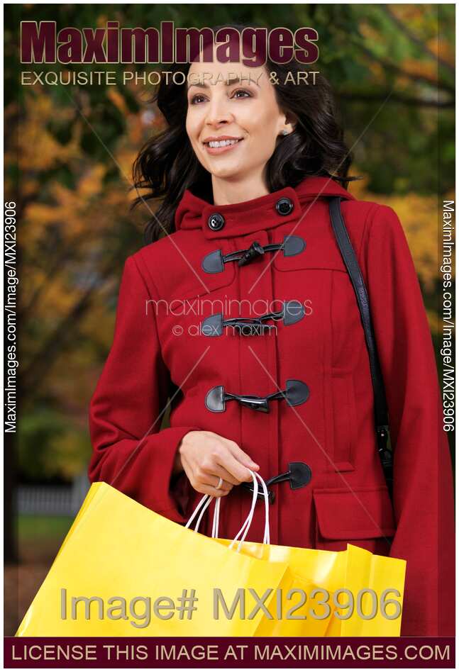 Happy Young Woman Walking with Shopping Bags