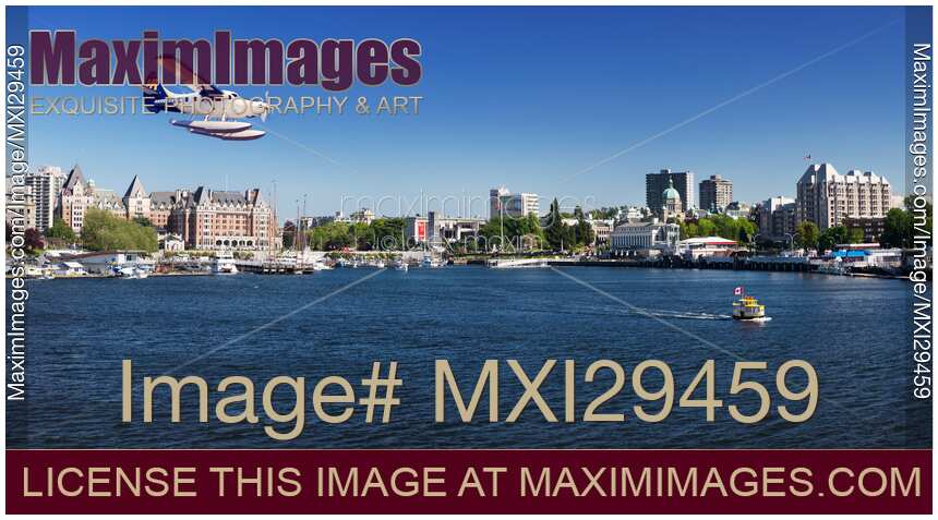 Harbour Air seaplane in front of Victoria BC harbour front skyline