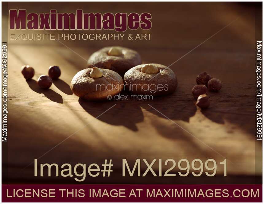 Healthy home-made Hazelnut butter cookies with hazelnuts on rustic table in dramatic sunlight