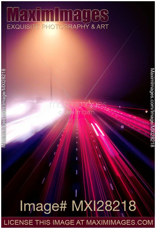 Highway traffic on foggy night