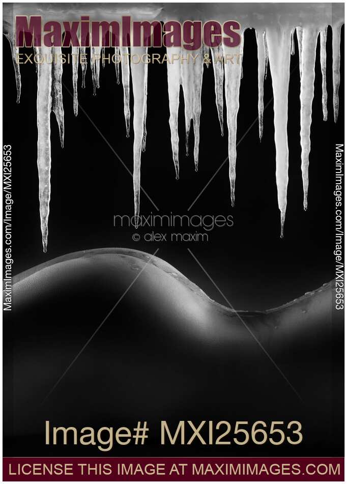 Hot naked woman body under melting icicles Black and white