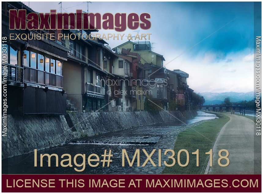 Houses and pathway along Kamo River on a misty morning in Kyoto