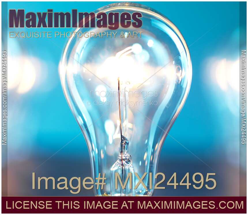 Illuminated light bulb on blue background