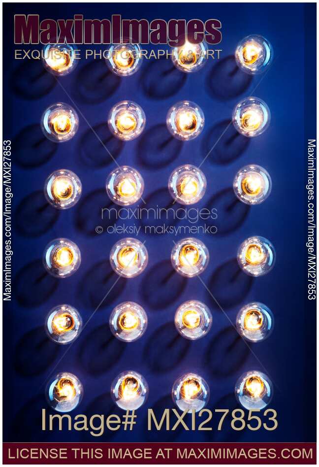 Illuminated light bulbs on blue background