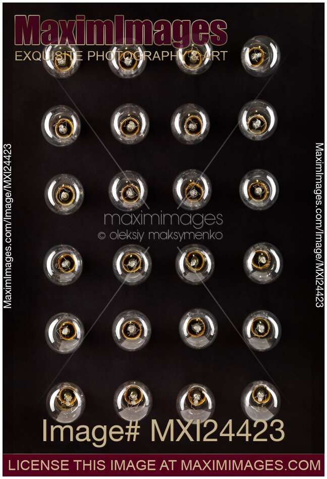 Incandescent light bulb turned off on black