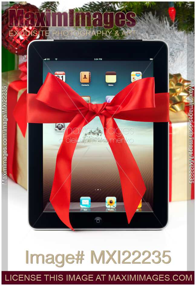 iPad with a Gift Bow under a Christmas Tree