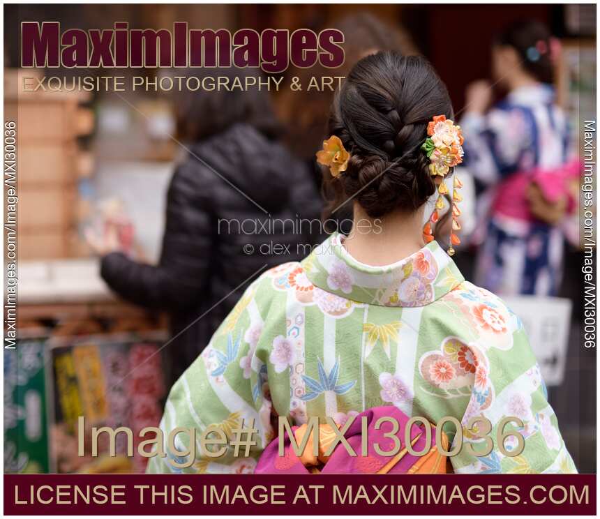 Japanese girl in colorful yukata kimono with pretty hairstyle and colorful Kanzashi hair ornament