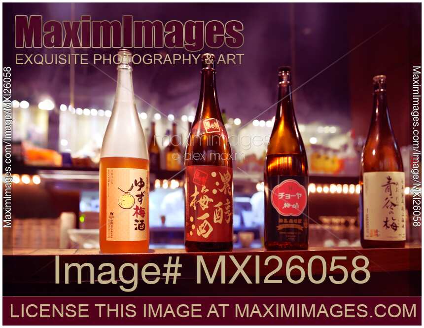 Japanese sake bottles on a bar counter