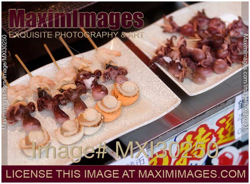 Japanese street food grilled seafood skewers with scallop and baby octopus