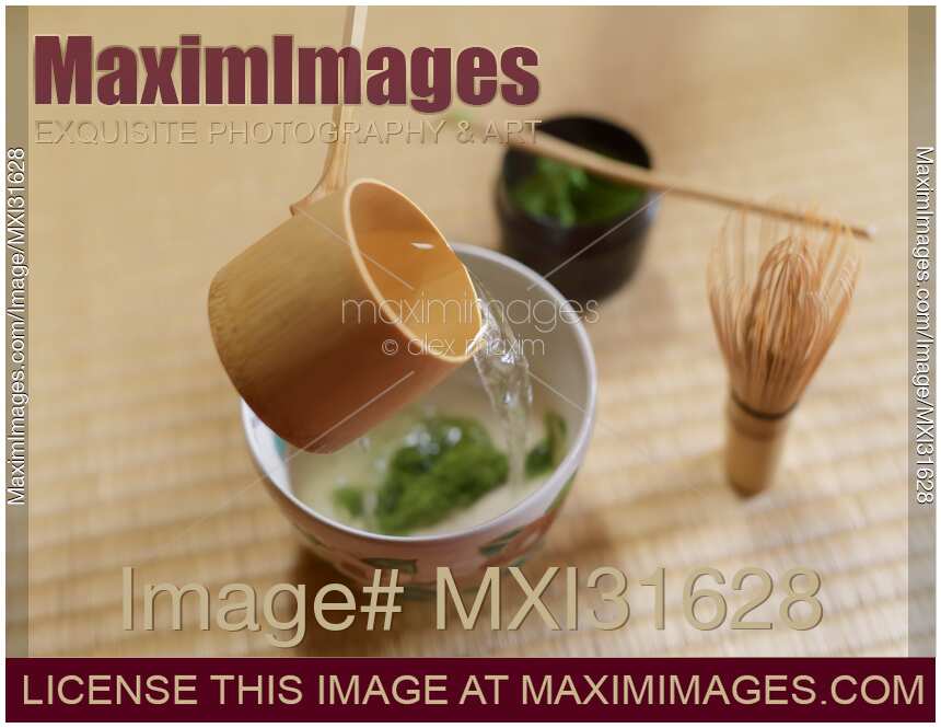 Japanese tea ceremony still life bamboo ladle pouring water into a matcha bowl Chawan