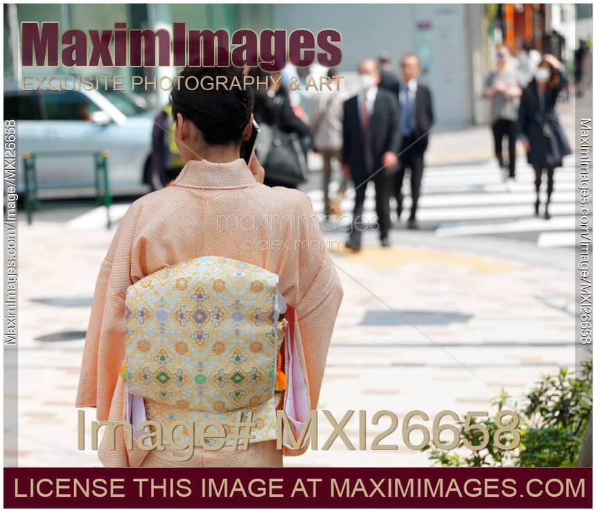 Japanese woman in kimono talking on cellphone