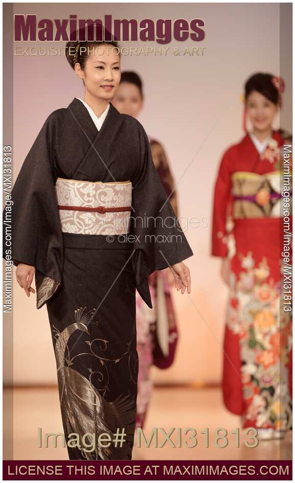 Japanese woman wearing an elegant black kimono with silver design