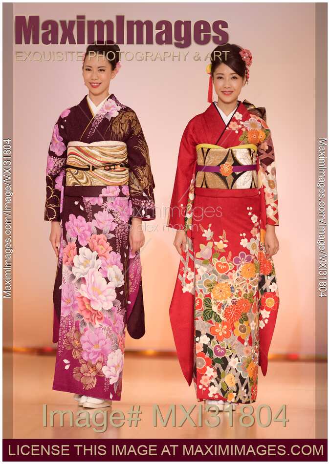 Japanese women in a beautiful kimonos with floral design at a fashion show in Kyoto
