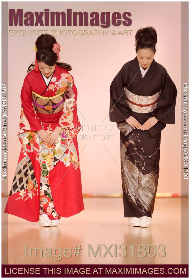 Japanese women in elegant kimonos bowing at a fashion show