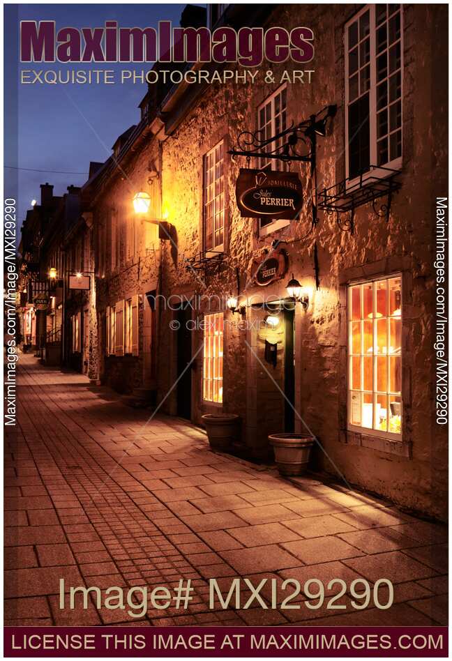 Jules Perrier and other shops lit with street light at night in Old Quebec City