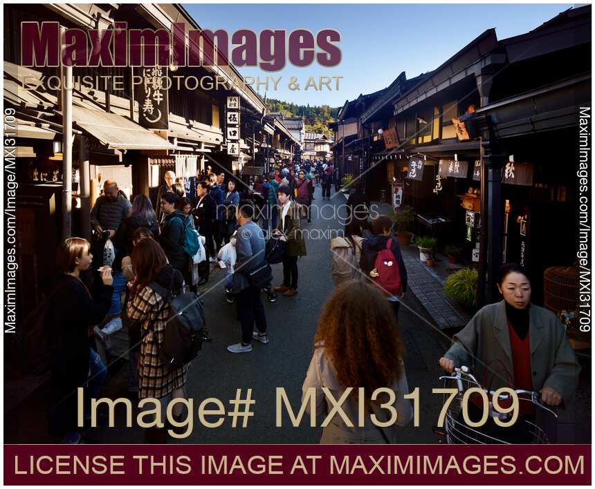 Kamisannomachi old merchant town street in Takayama Japan lined with shops and restaurants busy with tourists