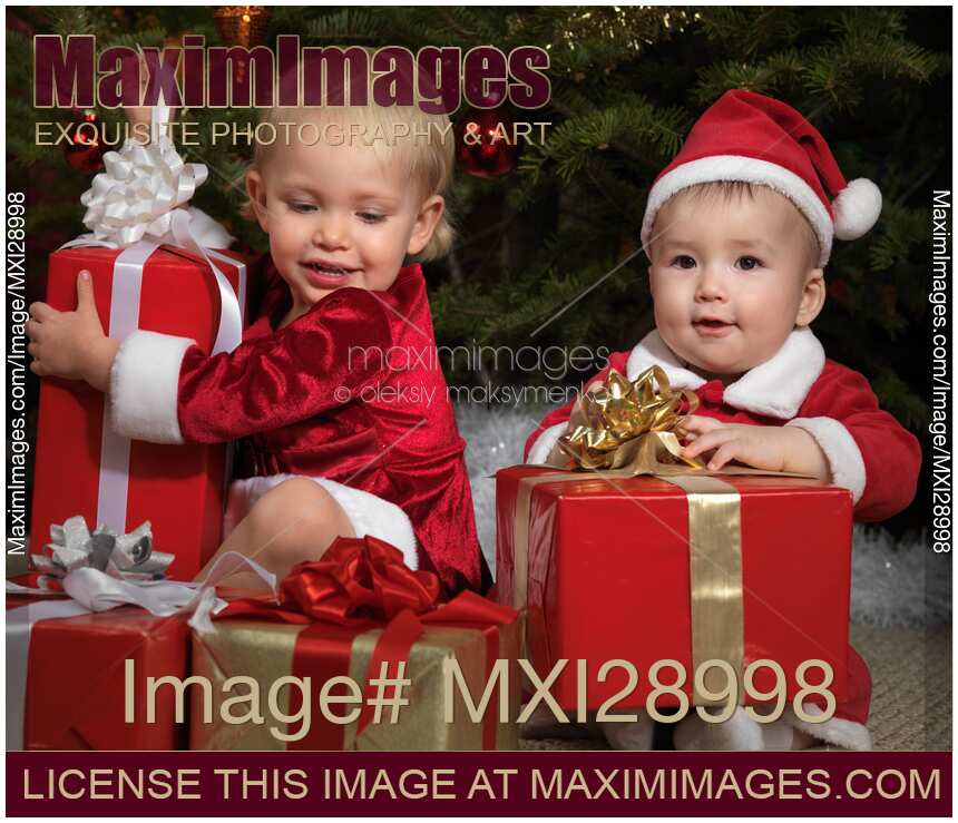 Kids Opening Gifts under a Christmas Tree