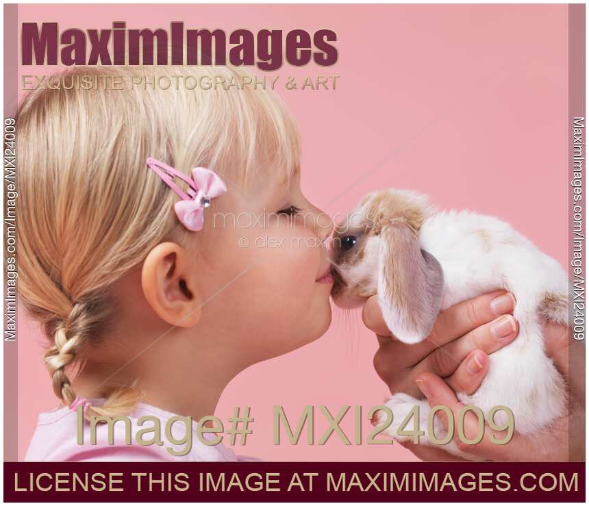 Little girl kising a bunny