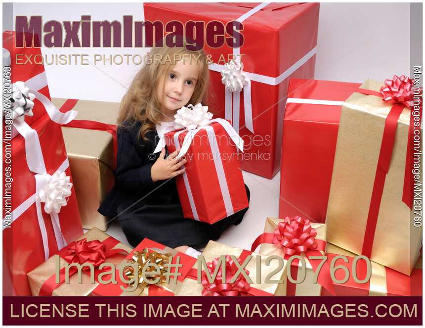 Little girl surrounded by Christmas gifts