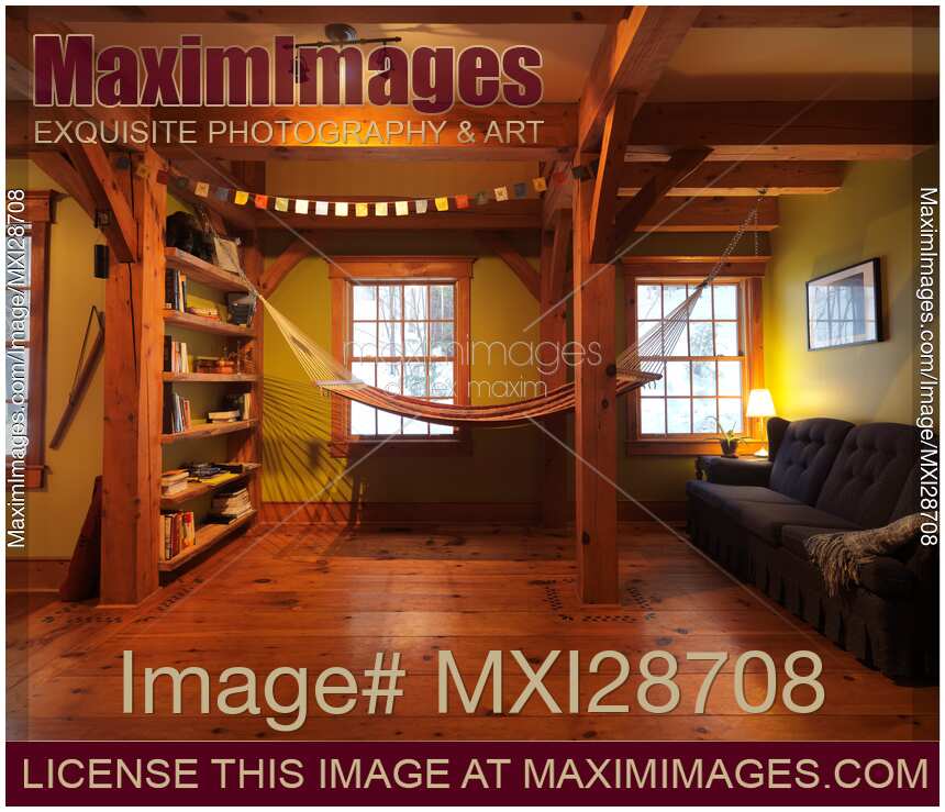 Lounge room with a hammock in timberframe Canadian house