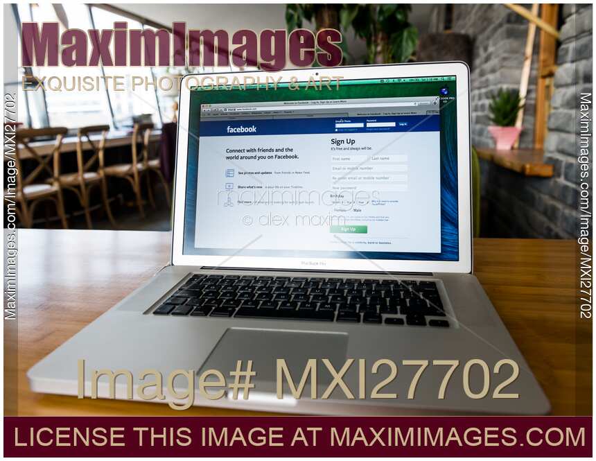 MacBook Apple laptop on a desk with Facebook on display