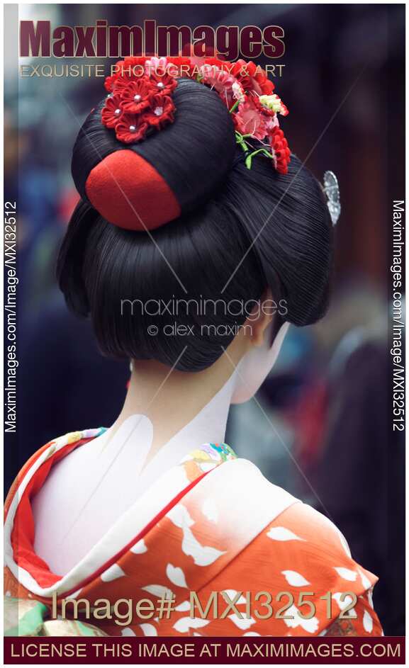 Maiko Geisha in bright red kimono back of her neck makeup and traditional hairstyle wig with kanzashi