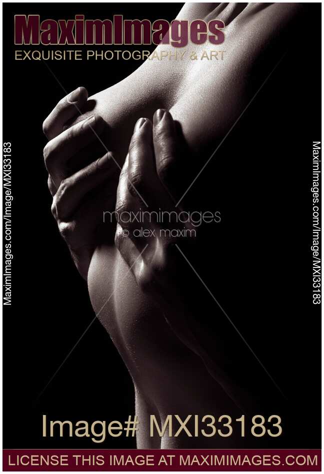 Male hands covering naked woman breasts, abstract fine art nude body parts of a couple making love.