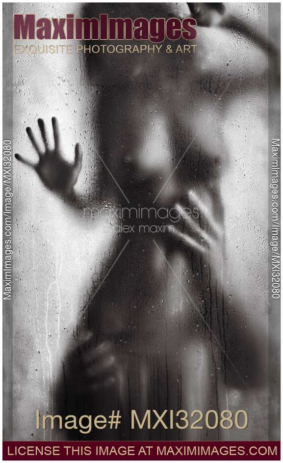 Man hands caressing woman half naked body Sensual couple behind wet glass Black and white art nude