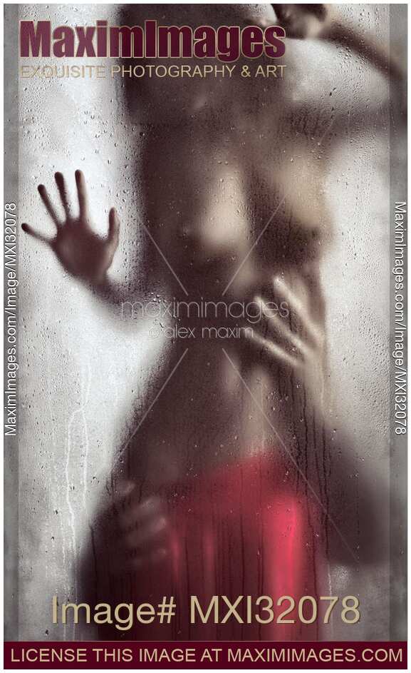 Man hands caressing woman half naked body Sensual couple behind wet glass