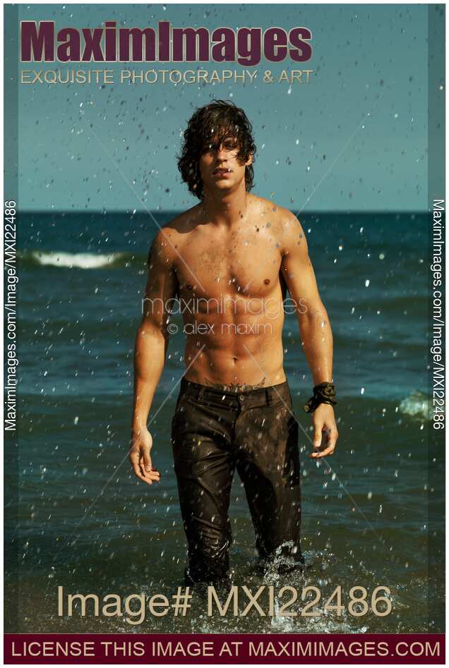 Man in Army Pants Walking Out of the Sea Water