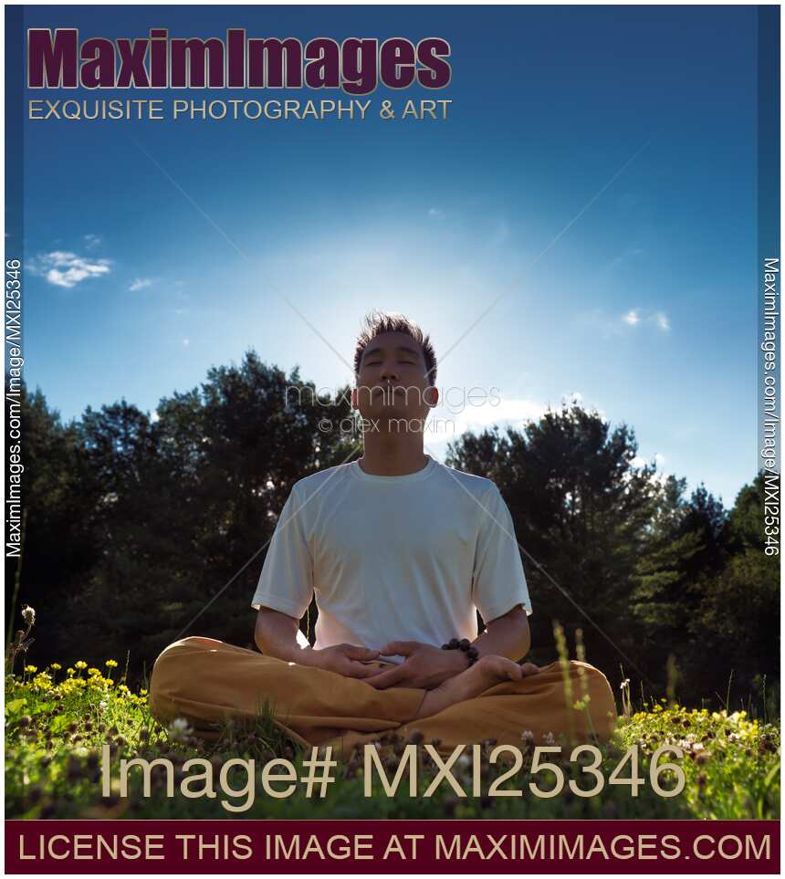 Man meditating in the nature during sunrise