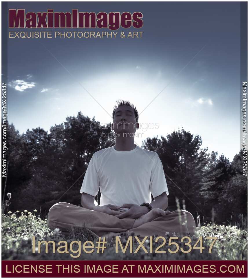 Man meditating in the nature during sunrise