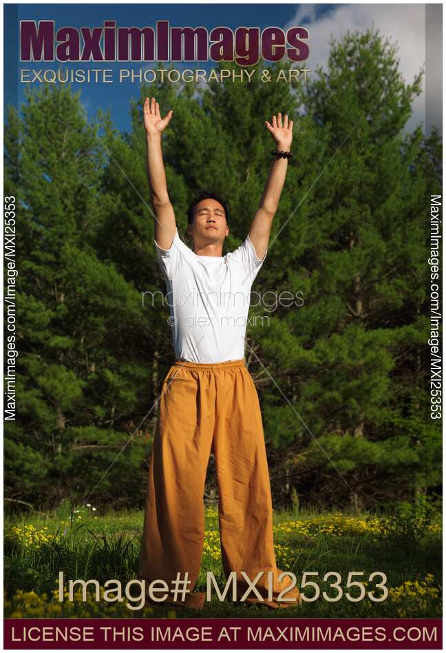 Man practicing sunrise Qi Gong meditation