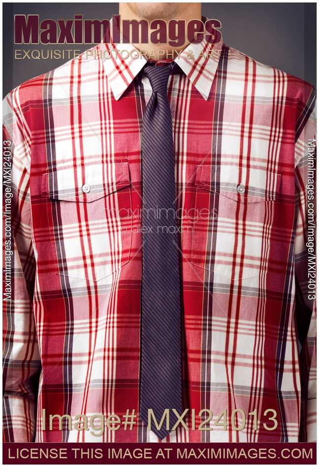 Man wearing red tartan shirt with a skinny necktie