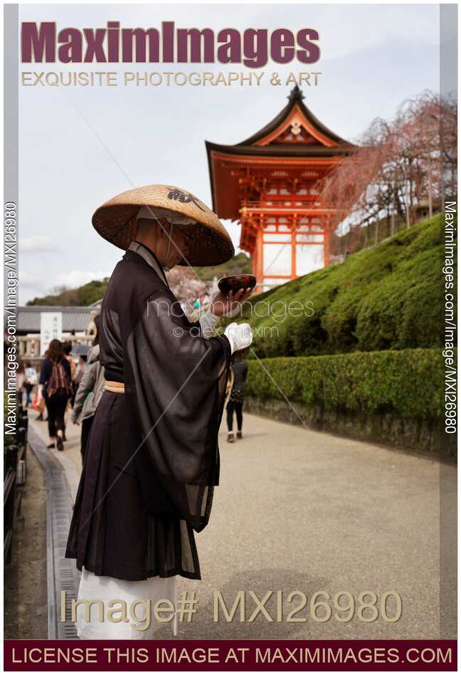 Mendicant Buddhist monk asking for donations