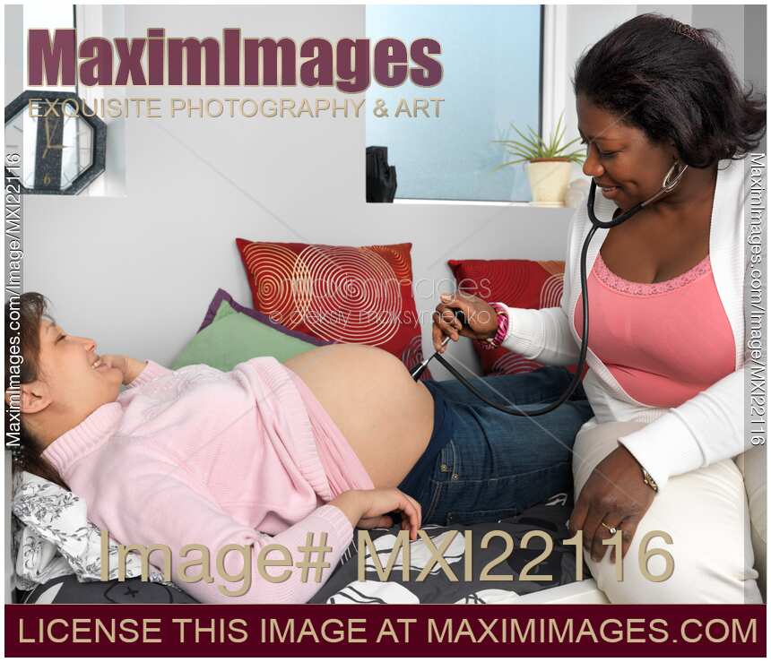 Midwife Checking Pregnant Woman Baby's Heartbeat